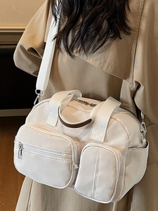 Large cream white nylon crossbody bag with multiple pockets and wide strap
