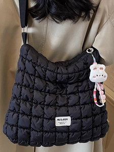 Black quilted puffer cloud bag with rabbit charm and wide shoulder strap for women