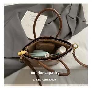 Internal storage view of the brown leather tote bag showing spacious compartments and items