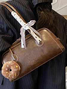 Retro dark brown leather underarm bag with a vintage texture and a decorative silk scarf