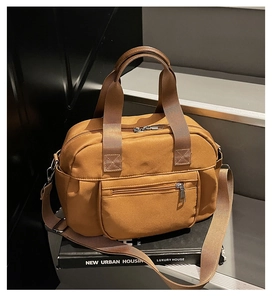 Detail of camel brown nylon multi-pocket shoulder bag with sturdy webbing handles