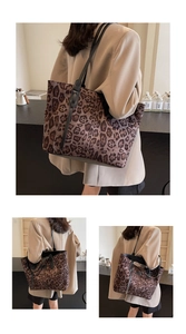 Close-up of leopard print large capacity tote bag with black leather shoulder straps
