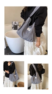 Detail view of monochrome checkered canvas tote bag with woven Sunshine Blossom label