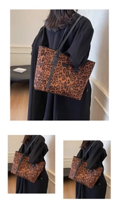 Close-up of leopard print canvas tote bag featuring premium black leather handles