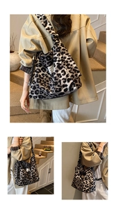 Detail of leopard print canvas tote bag featuring a white square woven label and wide strap