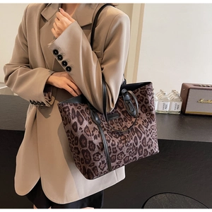 Close-up of leopard print tote bag with black leather handles and spacious interior