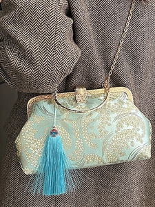 Elegant mint green embroidered shell bag with floral patterns and gold chain strap
