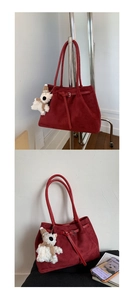 Detail of burgundy faux suede tote with leather strap buckle and cute bear pendant charm
