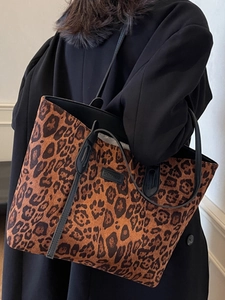 Large leopard print tote bag with black leather straps and brand logo for fashion commute