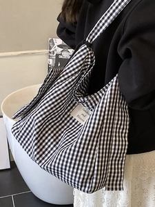 Chic black and white checkered canvas tote bag with wide shoulder strap for casual wear