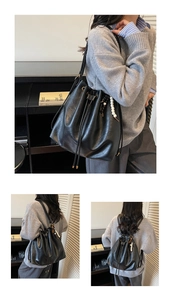 Detail of black bucket bag with drawstring closure and contrasting beaded charm