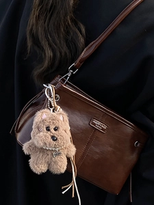 Retro dark brown oily leather crossbody bag with a cute plush doll charm
