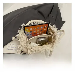 Flat lay of canvas tote bag interior showing spacious capacity for tablets and makeup