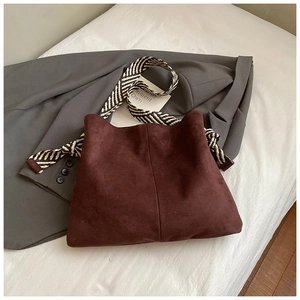 Dark coffee suede tote bag featuring a striped woven shoulder strap for a retro casual look