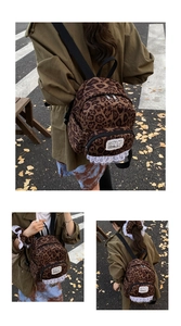 Detailed view of leopard print backpack featuring white lace trim and vintage style