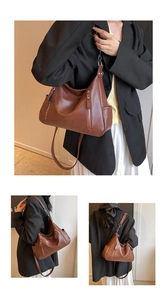 Close-up of soft brown leather tote bag showing side pockets and adjustable straps