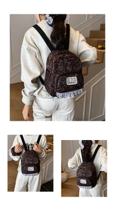 Detail view of mini leopard print backpack with white lace trim and matching hair scrunchie