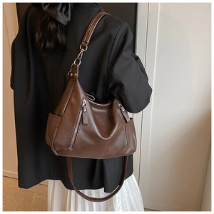 Detail of dark brown vintage shoulder bag showing large capacity and soft PU leather texture