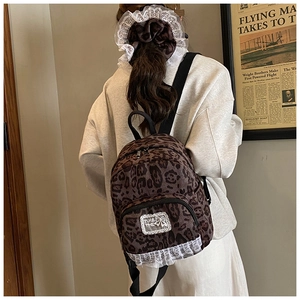 Detail of leopard print faux fur backpack with lace trim and matching hair scrunchie set