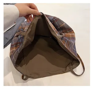 Internal view showing large capacity and signature lining of the plaid tote bag