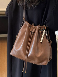 Retro brown drawstring bucket bag with beaded tassel and adjustable leather strap