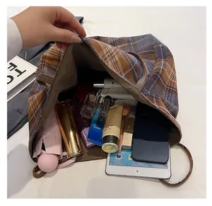 Detailed interior view of a plaid tote bag showing its large capacity for daily essentials