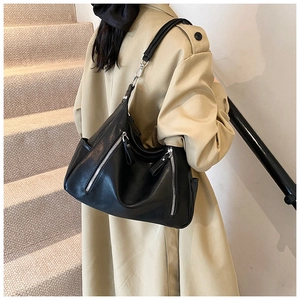 Black vintage leather tote bag with double zippers and silver metal buckles detail