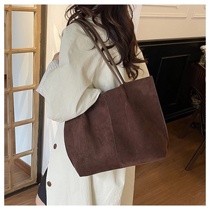 Brown suede tote bag shown on model shoulder for a casual vintage daily look