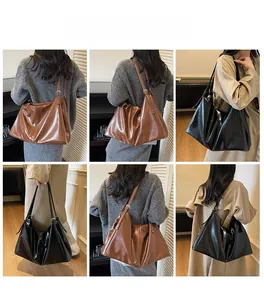 Detailed close-up showing texture of large soft leather tote bag in black and brown