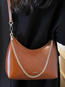 Brown leather underarm bag with glossy finish and silver chain strap for women