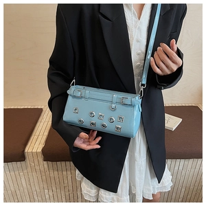 Details der hellblauen Lackledertasche mit silbernen Ösen und Schnallenverzierung