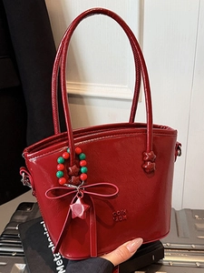 Fashionable wine red glossy leather tote bag with a decorative beaded star charm