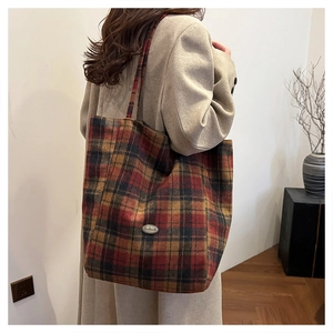 Side view of a vintage plaid tote bag showing its large capacity on a model's shoulder