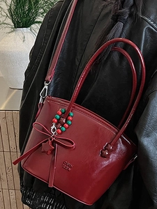 Fashionable dark red glossy leather bucket bag with bow detail and star pendant for women