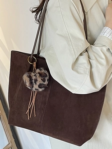 Retro large brown suede tote bag with leopard heart charm and tassel worn by model