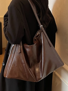 Classic dark brown glossy leather tote bag for women with adjustable shoulder straps