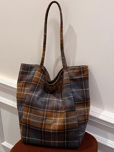 Classic brown plaid tote bag in tweed fabric with spacious design and metal logo detail