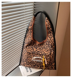 Detail of leopard print canvas tote with Noronoro pocket and colorful decorative knots