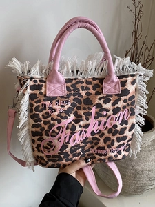 Fashionable leopard print canvas tote bag with pink straps and fringe details