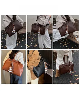Outdoor shot of a large tote bag in coffee, dark brown, tan, and black with a dog charm
