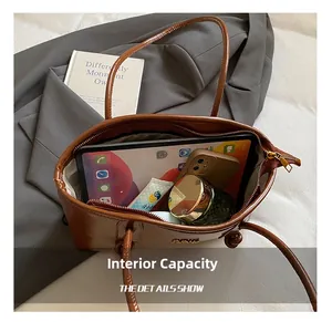 Detailed interior of brown leather tote bag showing large capacity for tablet and cosmetics