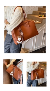 Brown faux leather tote bag detail with schnauzer charm and woven checkerboard tassel