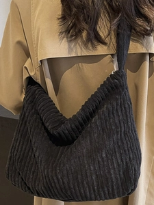 Minimalist black corduroy hobo tote bag with vertical texture for daily casual use