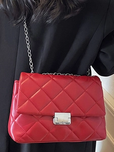 Red quilted square crossbody bag with silver chain strap and metal lock closure for women