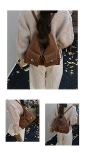 Detail view of vintage brown tote bag with contrast stitching and silver metal turn-locks