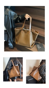 Detailed view of large brown crocodile pattern tote bag with slim shoulder straps