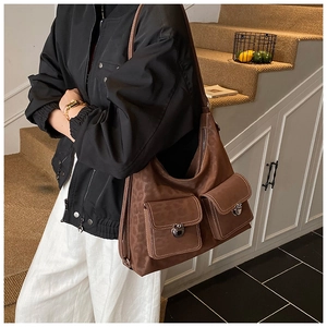 Detail of retro large brown leopard print shoulder bag with functional front pockets