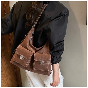 Detail showing deep brown leopard print texture with metal buckles and contrast stitching