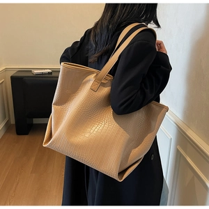 Close-up of the large beige tote bag featuring elegant crocodile embossed texture on faux leather