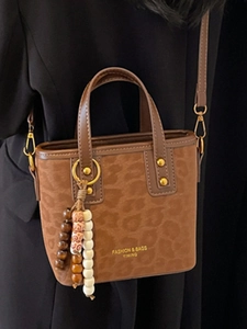 Retro leopard print bucket bag in brown suede with decorative wooden beads and shoulder strap